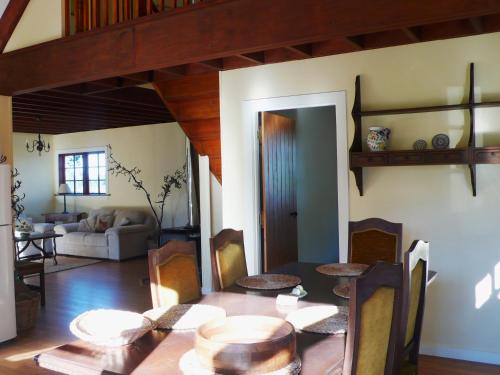 a dining room with a table and a living room at Gunyah Country Estate in Windwhistle