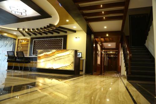 a lobby of a hotel with a large painting on the wall at Beverly villa in Ooty