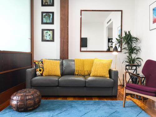 ein Wohnzimmer mit einer Couch und einem Spiegel in der Unterkunft Private apartments in a Landmark Heritage Building in Auckland