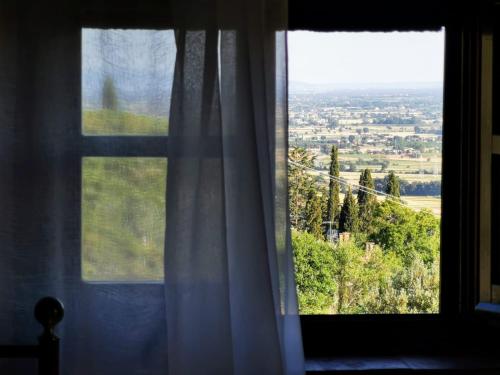 a window with a view of a city at Villa Schiatti in Cortona