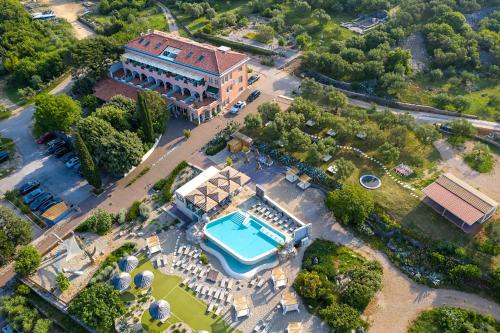 an aerial view of a mansion with a swimming pool at Hotel Kanajt in Punat