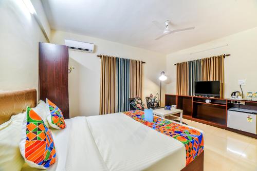a hotel room with a bed and a tv at FabHotel K7 Trends Baga in Calangute
