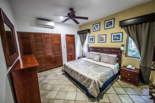 een slaapkamer met een bed en een plafondventilator bij Villa Holiday Playa Del Carmen in Playa del Carmen