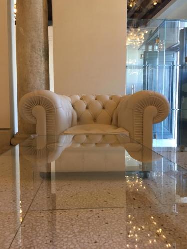 a couch sitting in a lobby with a reflection of it at Ca' Bonfadini Historic Experience in Venice