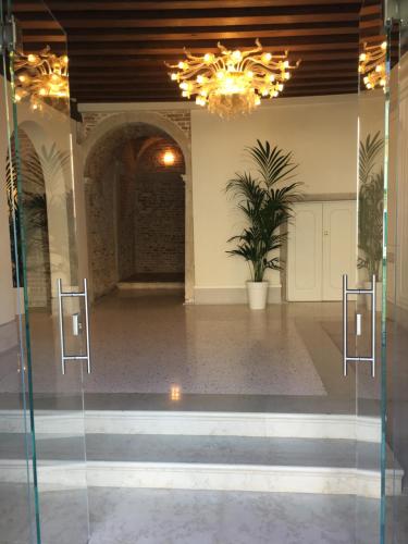 a glass door in a room with a potted plant at Ca' Bonfadini Historic Experience in Venice