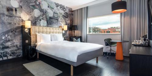 a hotel room with a bed and a table and a window at Radisson Blu Riverside Hotel in Gothenburg