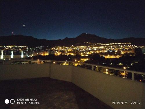 a view of a city at night with lights at Benalbeach JR Suite in Málaga