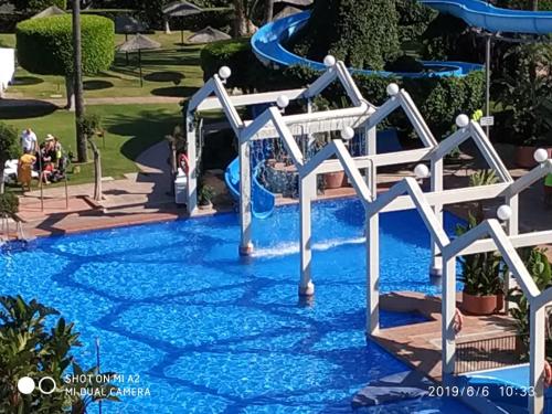 a slide in the water at a resort at Benalbeach JR Suite in Málaga