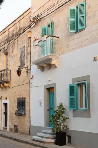 a building with a blue door and green shutters at MYN in Rabat in Rabat
