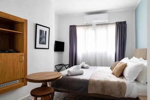 a bedroom with a bed with a table and a window at MYN in Rabat in Rabat