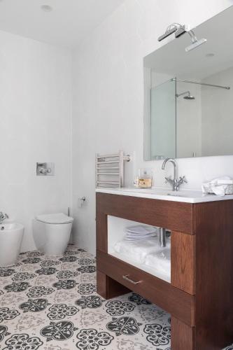 a bathroom with a sink and a toilet and a mirror at MYN in Rabat in Rabat