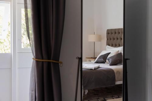 a bedroom with a bed and a mirror at MYN in Rabat in Rabat