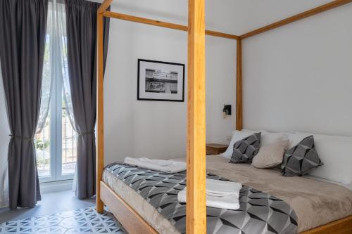 a bedroom with a canopy bed and a window at MYN in Rabat in Rabat