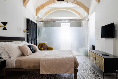 a bedroom with a large bed and a tv at MYN in Rabat in Rabat