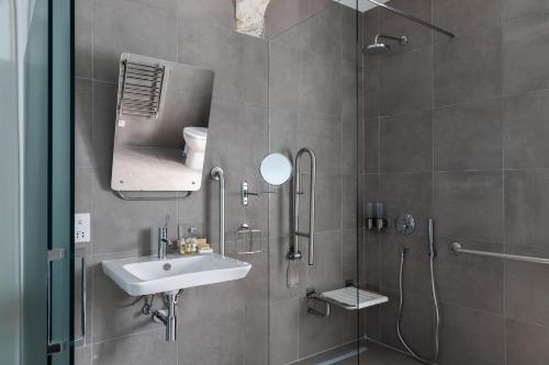 a bathroom with a sink and a shower with a mirror at MYN in Rabat in Rabat