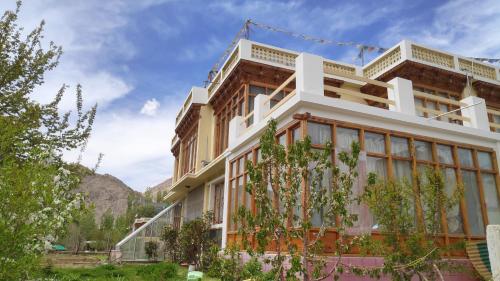 a building with trees in front of it at THE WILLOW HOUSE in Leh