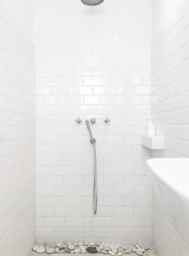a white bathroom with a shower and a sink at WHITE HOUSE - silesian loft apartment in Dąbrowa Górnicza