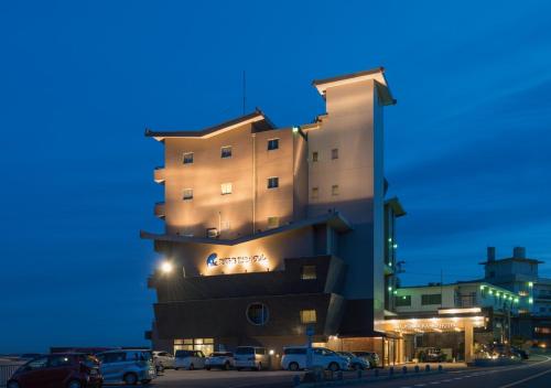 a building with cars parked in front of it at Awakan in Sumoto