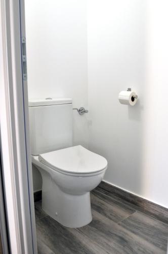 a bathroom with a toilet and a roll of toilet paper at Ibanova Appartements in Collioure