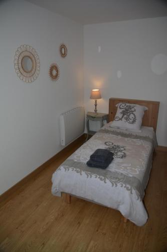 a bedroom with a bed with a wooden floor at la maison du saussoy in Saint-Augustin