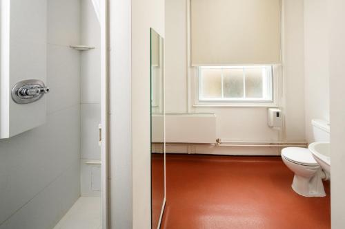 a bathroom with a toilet and a sink at Christ's College Cambridge in Cambridge