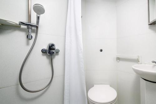 a bathroom with a shower with a toilet and a sink at Christ's College Cambridge in Cambridge