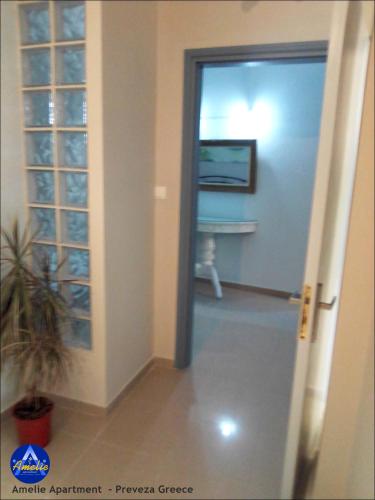 a hallway with a door leading into a room at Amelie Apartment in Preveza