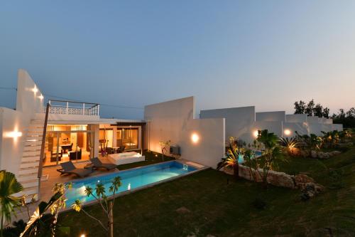 a villa with a swimming pool at night at Feliz Villa Suite Irabujima Sawada in Miyako-jima