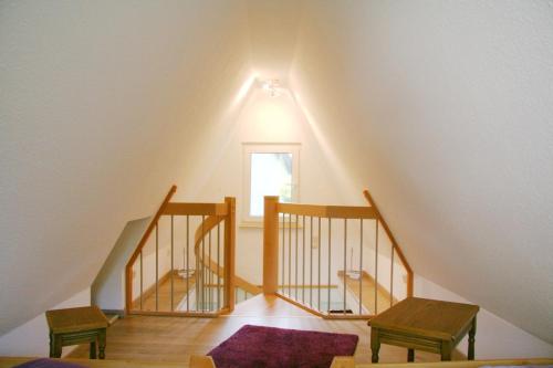 a attic room with a staircase and a window at Strandstübchen in Zingst