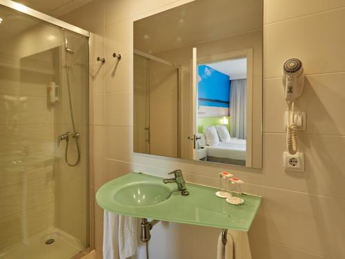 a bathroom with a sink and a shower and a mirror at BQ Carmen Playa- Adults Only in Playa de Palma