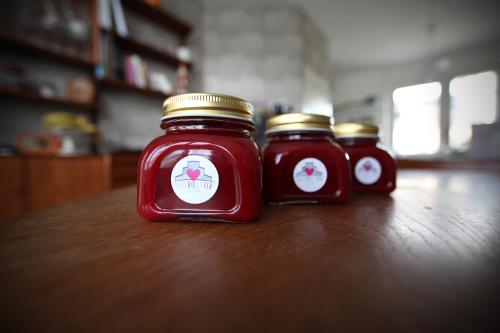 three jam jars sitting on a wooden table at Chez Ric et Fer in Coucy-le-Château-Auffrique
