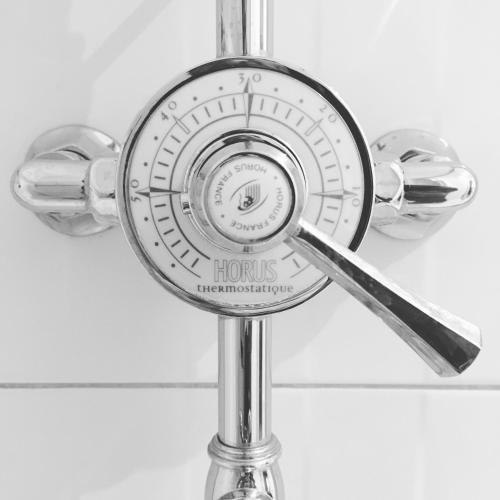 a shower head on a pole in a bathroom at Chez Ric et Fer in Coucy-le-Château-Auffrique