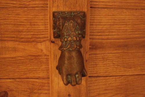 a wooden door with a glove hanging on it at Chiesa Ignano 1778 in Marzabotto