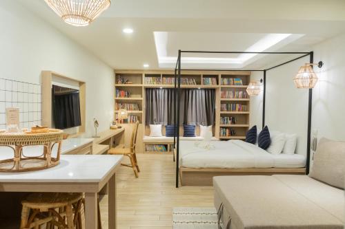 a bedroom with a bed and a living room at Amaka Bed and Breakfast in Chiang Mai