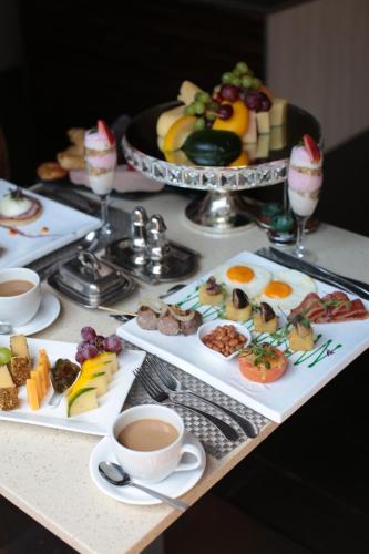 a table with plates of food and cups of coffee at Palala Boutique Game Lodge and Spa in Tom Burke