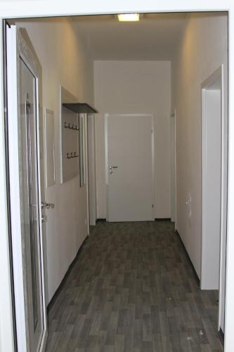 an empty hallway with white walls and wood floors at Apartment Fonhauser in Amstetten