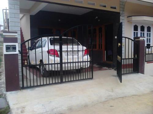 a white car parked inside of a garage at Sili Homestay in Madikeri