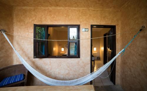 a room with a hammock hanging from the wall at Hotel Barrio Latino in Playa del Carmen