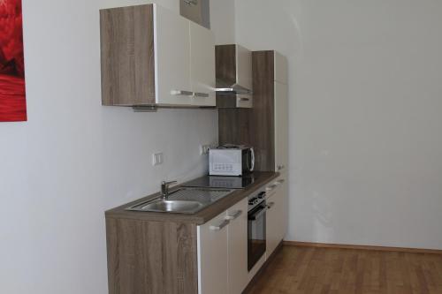a small kitchen with a sink and a microwave at Apartment Fonhauser in Amstetten