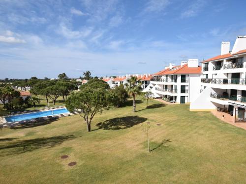 an aerial view of a building and a yard at Spacious Apartment in Quarteira with Swimming Pool in Vilamoura