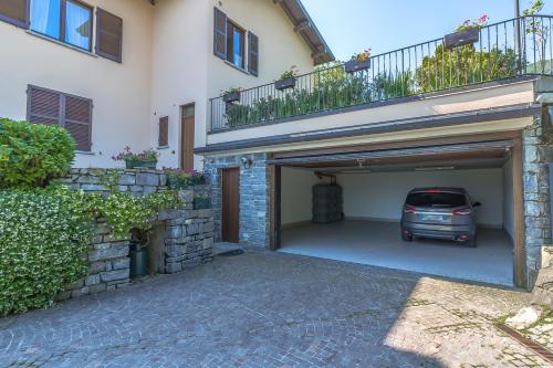 a garage with a car parked under a building at Villa La Perla - Bellagio in Bellagio