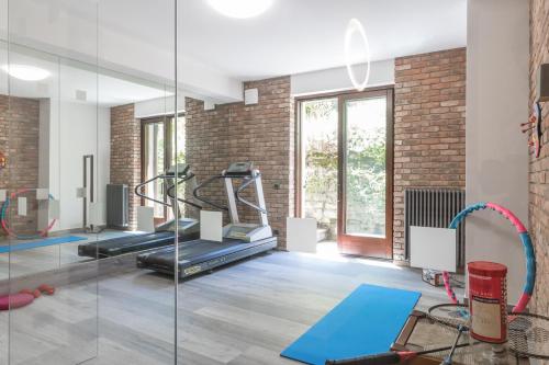a gym with a treadmill and a glass wall at Villa La Perla - Bellagio in Bellagio