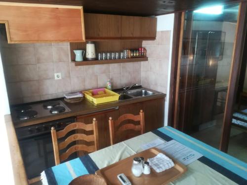 a kitchen with a table and a sink and a stove at Apartments Darinka in Opatija