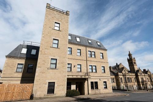 a large brick building with a clock tower in the background at Halifax House, Studio Apartment 213 in Halifax