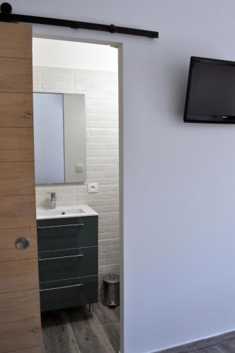 a bathroom with a sink and a mirror at Ibanova Appartements in Collioure