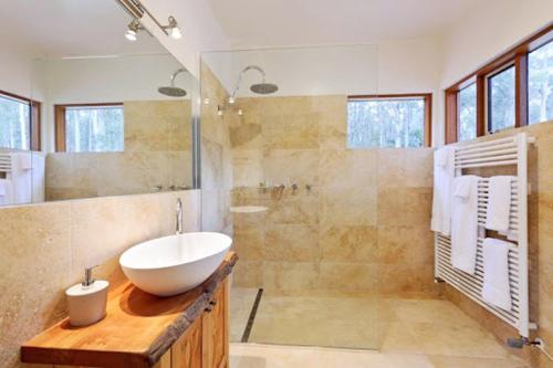 a bathroom with a white sink and a shower at Adventure Bay Retreat Bruny Island in Adventure Bay
