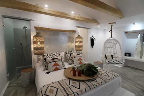 a bedroom with a bed and a bird cage at Annio studios in Plaka