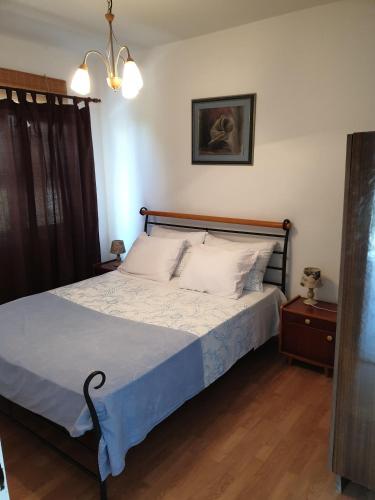 a bedroom with a bed with a blue comforter at Apartments Paradiso Murter in Murter
