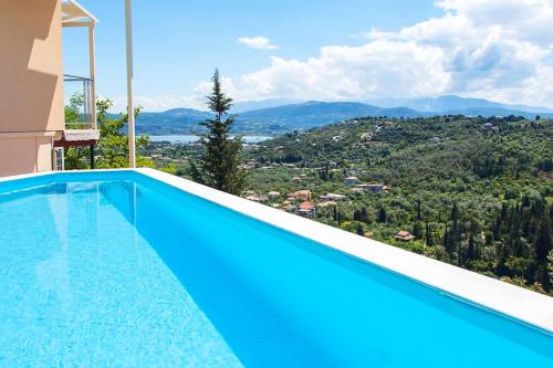 a swimming pool with a view from a house at Villa Alba in Apolpaina