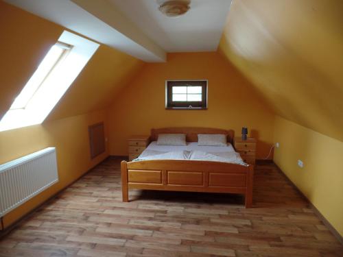a bedroom with a bed and two windows at Pension Restaurant Bobrovník in Lipova Lazne